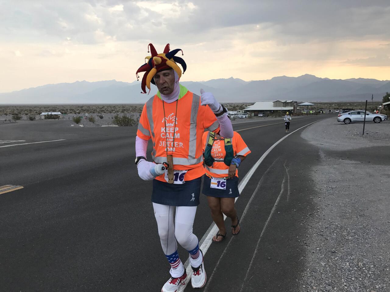 Ed Ettinghausen, 54, of Murrietta, CA, holds the world's record for the most 100-mile runs. He puts ice under his jester's hat to stay cool. He is at Mile 42 of 135.