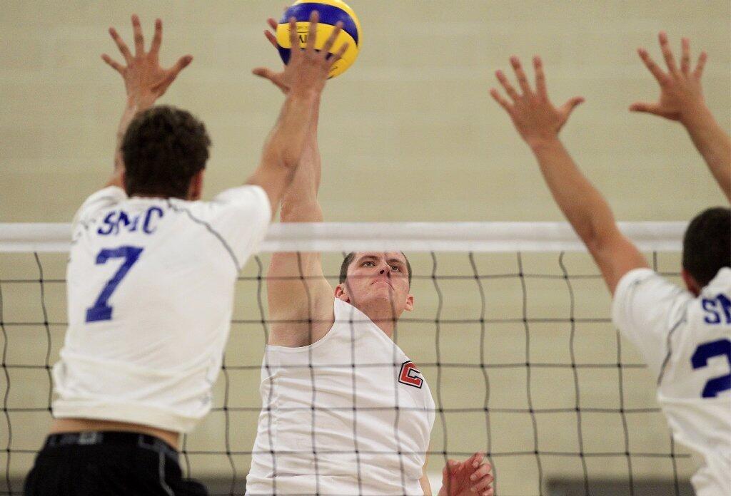 Orange Coast College's Jim Webb, center, battles at the net against Santa Monica in the 2014 California Community College Athletic Assn. State Championship match at Santiago Canyon College in Orange on Friday.