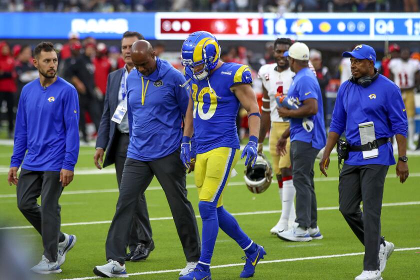 Inglewood, CA - October 30: Rams wide receiver Cooper Kupp walks off the field with medical staff after getting injured and apparently avoided a major injury at the end of Sunday's loss to the 49ers. Kupp is expected to play against the Buccaneers this week. The 49ers beat the Rams 31-14 at SoFi Stadium in Inglewood Sunday, Oct. 30, 2022. (Allen J. Schaben / Los Angeles Times)