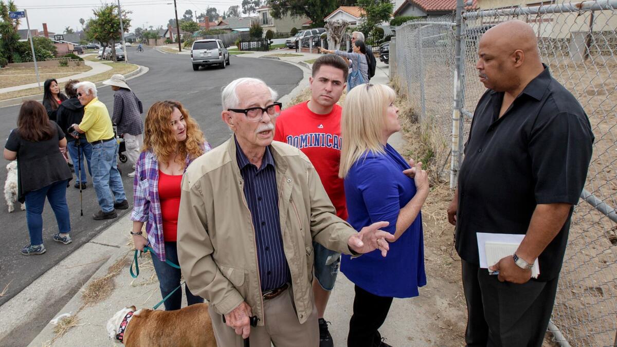 Project opponents Charles Jerman, foreground, and Ronald Robinson, right, with other Harbor Gateway neighbors. (Irfan Khan / Los Angeles Times)