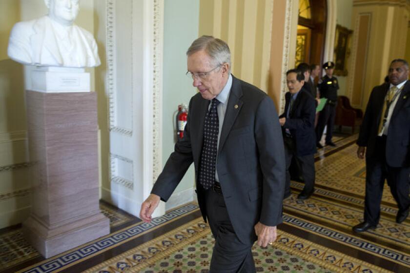 Senate Majority Leader Harry Reid leaves a caucus on Capitol Hill. Reid on Thursday announced that gun control legislation would be tabled for the time being.