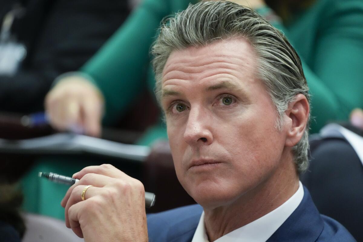 California Gov. Gavin Newsom holding a pen at a climate summit at the Vatican
