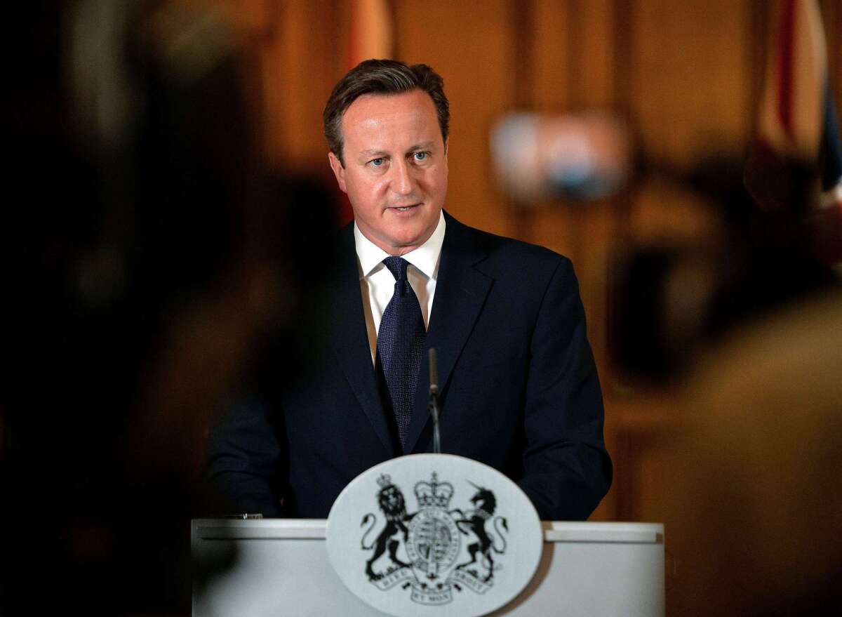British Prime Minister David Cameron delivers a statement in London on Sunday. "We will do everything in our power to hunt down these murderers and ensure they face justice, however long it takes," he said of the Islamic State militant group.