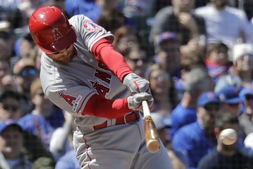 Los Angeles Angels' Zack Cozart hits an RBI single during the second inning of a baseball game against the Chicago Cubs, Saturday, April 13, 2019, in Chicago. (AP Photo/Nam Y. Huh)