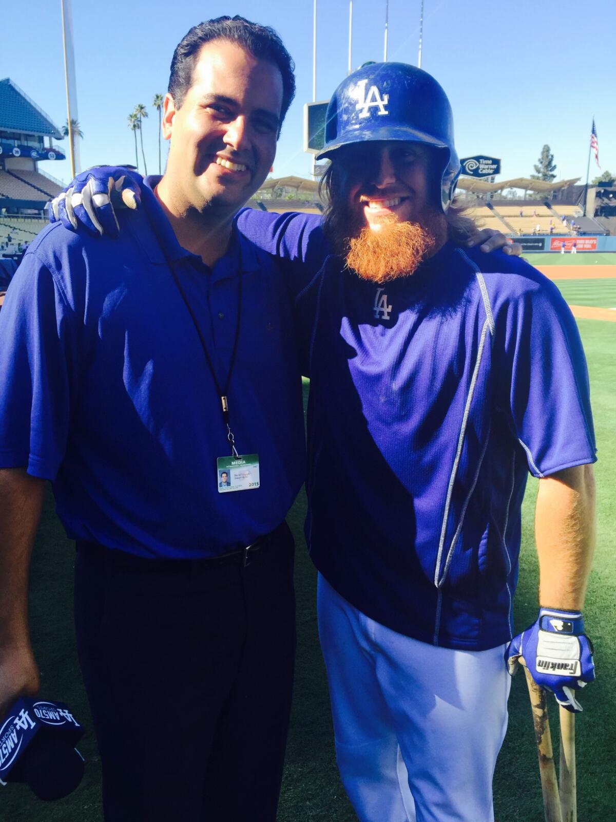 Radio reporter David Vassegh and Dodgers third baseman Justin Turner stand together near the field.