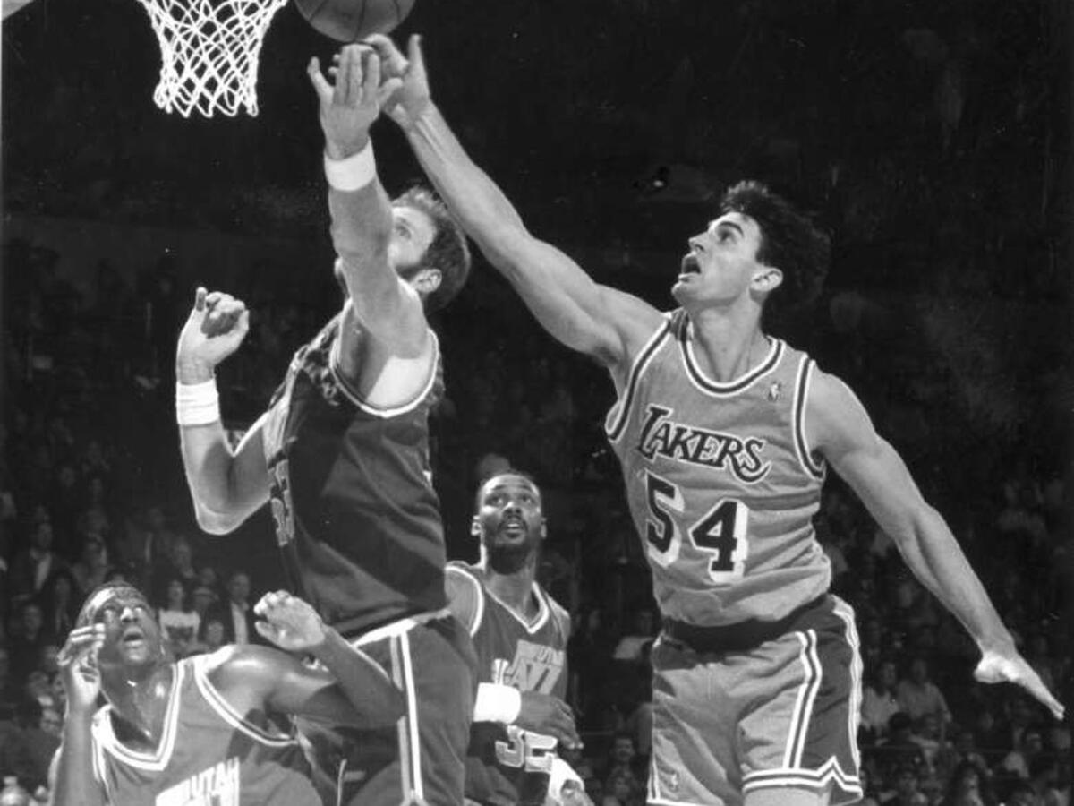 Former Laker Jack Haley and Utah's Mark Eaton, left, battle for a rebound during a game in December of 1991. Haley died Monday. He was 51.