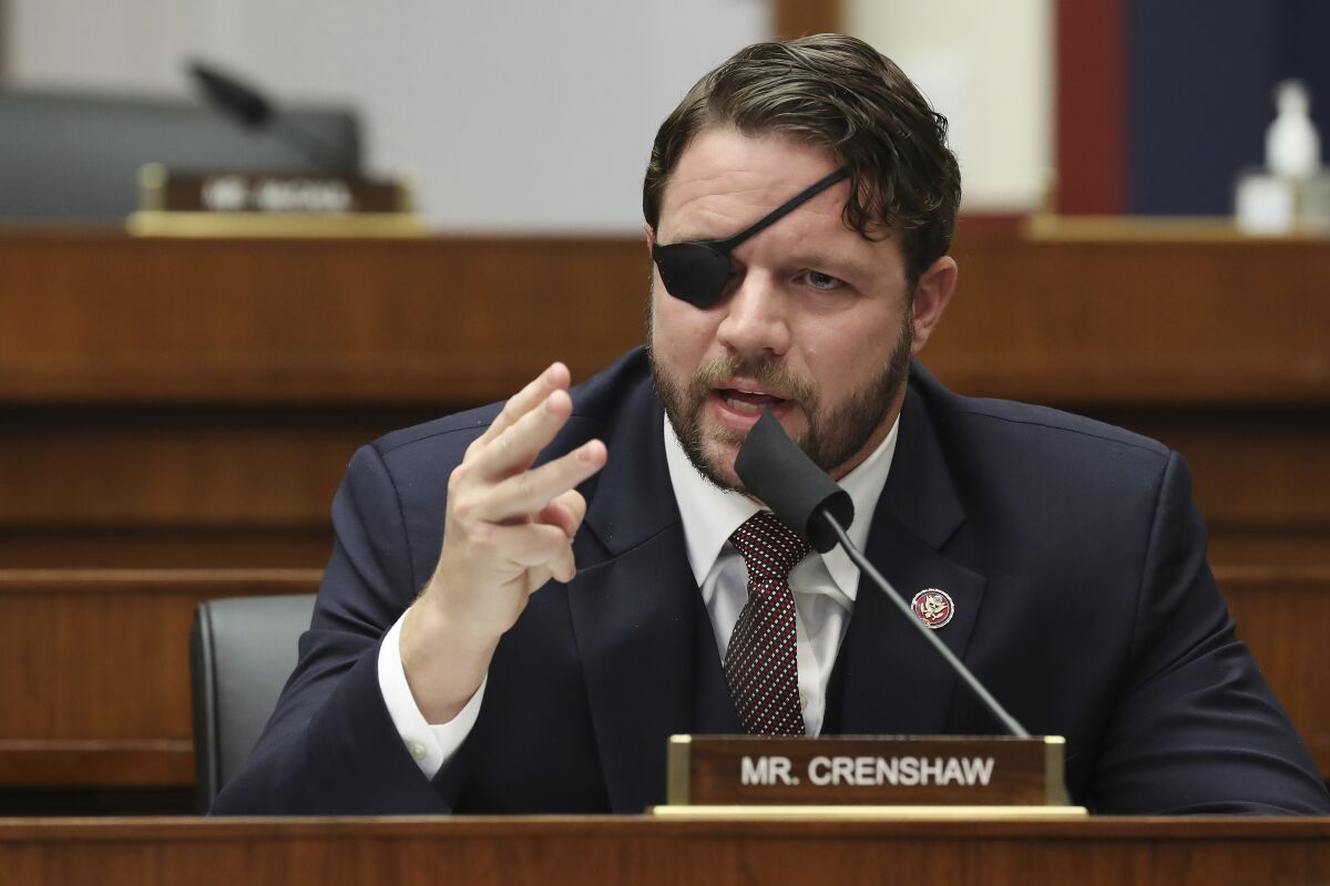 A man with an eye patch, sitting at a congressional hearing behind a placard that says "Mr. Crenshaw"