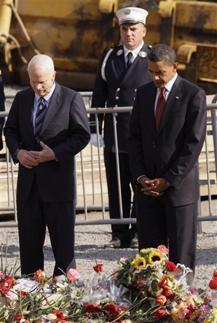 Presidential candidates Sen. John McCain, R-Ariz., left, and Sen. Barack Obama, D-Ill., observe a moment of silence together at ground zero on the seventh anniversary of the attacks on the World Trade Center Thursday, Sept. 11, 2008 in New York. (AP Photo/Julie Jacobson, Pool)