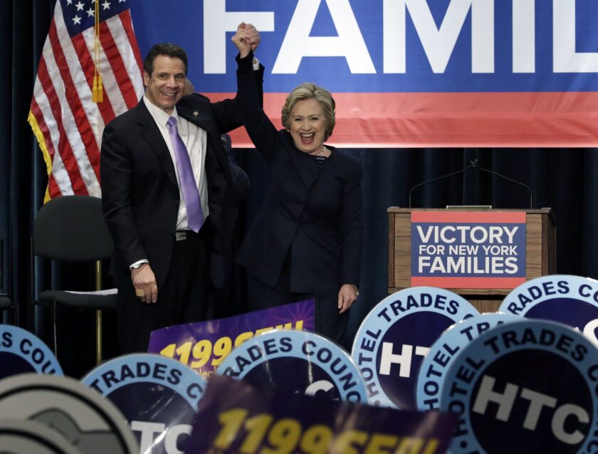 Hillary Clinton at a rally in Manhattan with New York Gov. Andrew Cuomo after he signed the state's $15 minimum wage into law Monday.