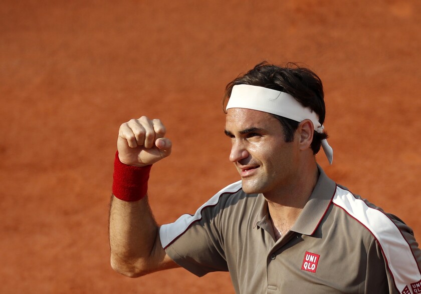 FILE - In this Tuesday, June 4, 2019 file photo, Switzerland's Roger Federer celebrates winning his quarterfinal match of the French Open tennis tournament against Switzerland's Stan Wawrinka in four sets, 7-6 (7-4), 4-6, 7-6 (7-5), 6-4, at the Roland Garros stadium in Paris. Roger Federer announced Sunday April 18, 2021, he will play at the French Open, and the Swiss star is preparing for it on home clay at a tournament in Geneva next month. (AP Photo/Jean-Francois Badias, File)