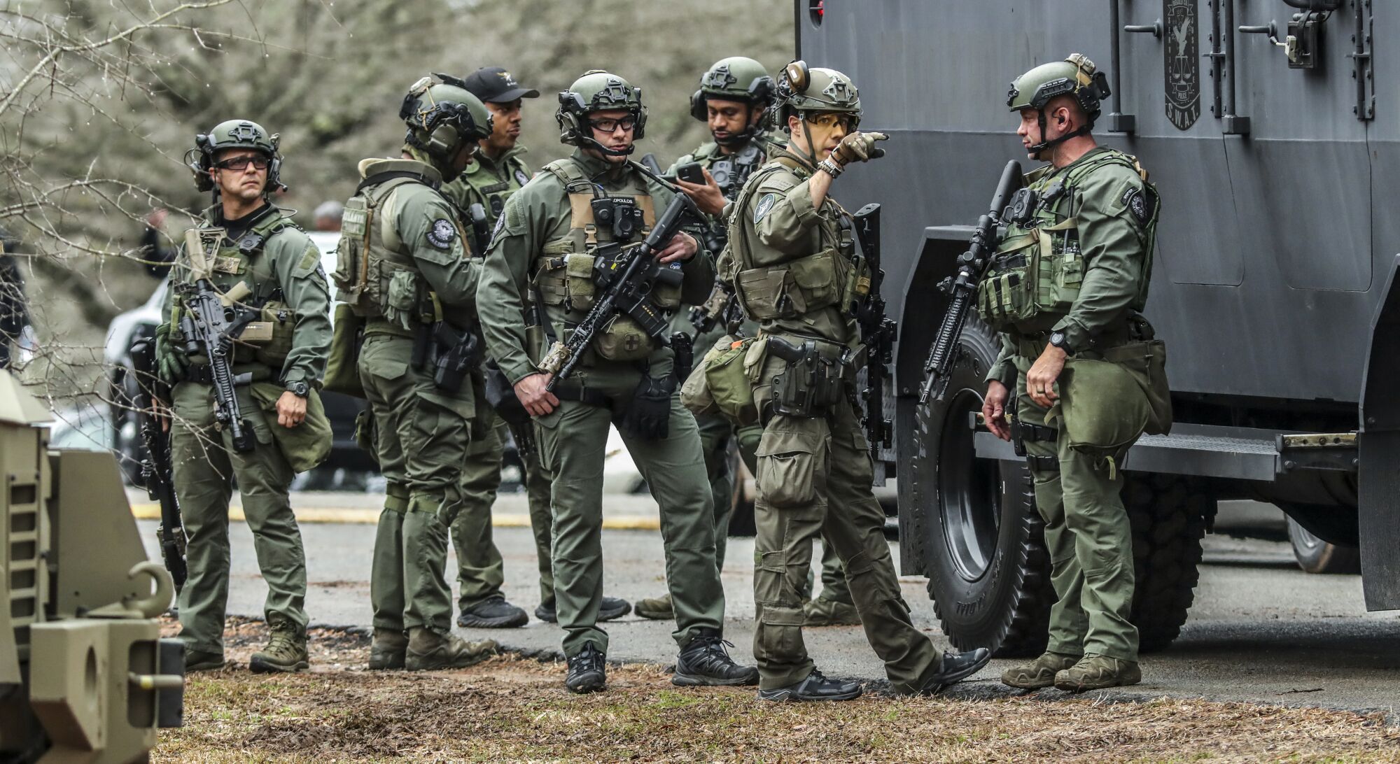 SWAT members are pictured leaving the Gresham Park command post in Atlanta after conducting a "clearing operation."