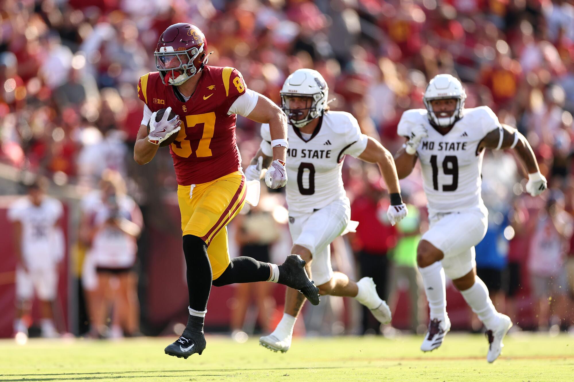 USC tight end Lake McRee scores on a 64-yard reception against Missouri State at the Coliseum.