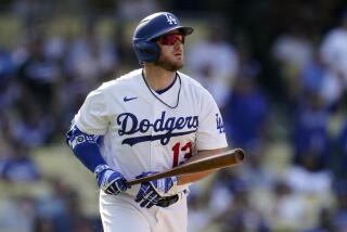 Los Angeles Dodgers' Max Muncy watches his three-run home run against the San Francisco Giants.