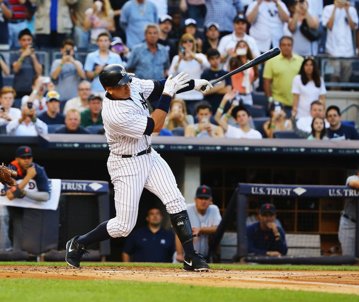 Alex Rodriguez of the New York Yankees hits a home run to get his 3,000th career hit in the first inning of a game Friday against the Detroit Tigers in New York City.