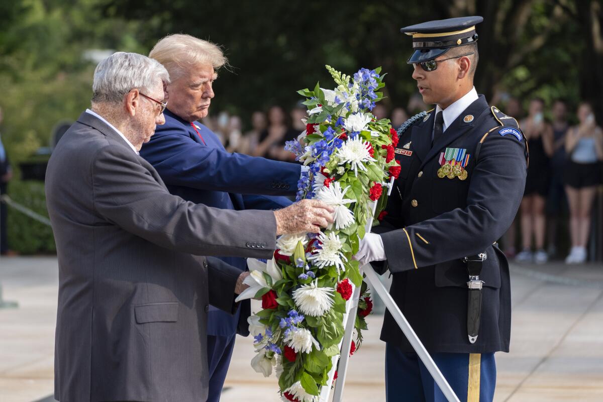 Former President Trump and others laying a wreath.