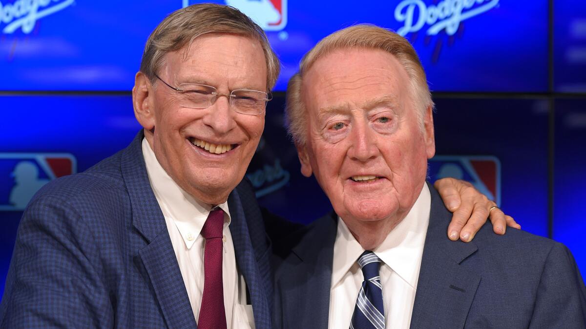 Outgoing MLB Commissioner Bud Selig, left, poses with Dodgers announcer Vin Scully before a game between the Dodgers and Arizona Diamondbacks in September.