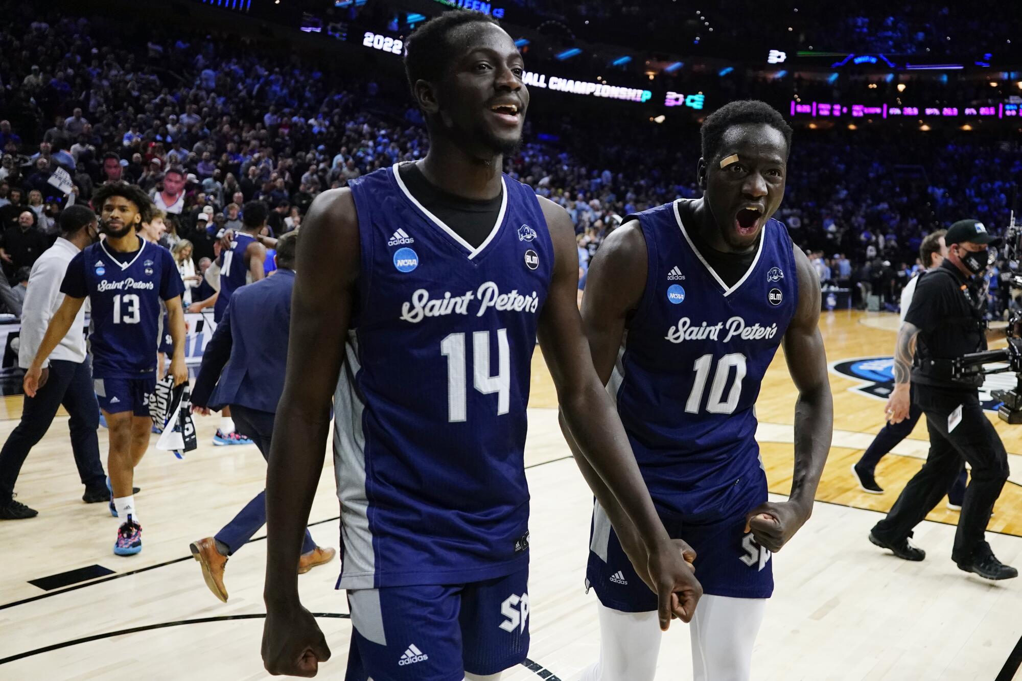 Saint Peter's Fousseyni Drame and Hassan Drame celebrate after defeating Purdue.