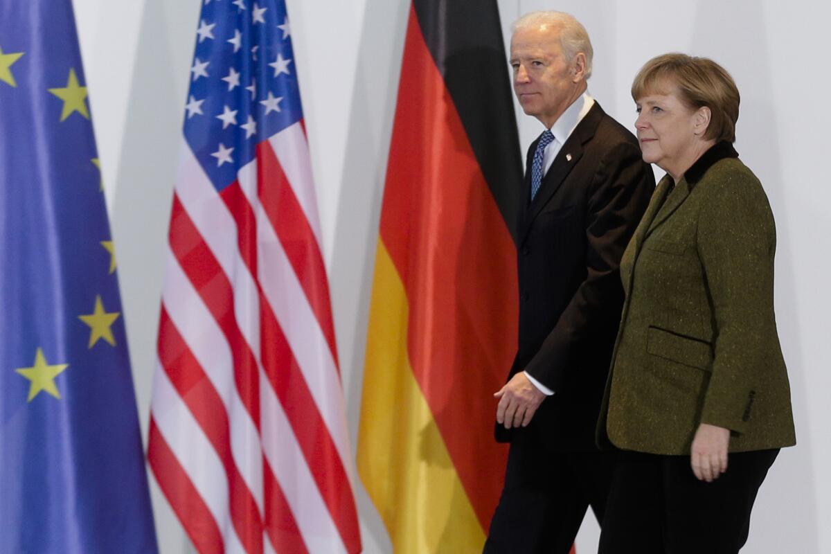 FILE - In this Feb. 1, 2013 file photo, German Chancellor Angela Merkel, right, and United States' Vice President Joe Biden walk at the chancellery in Berlin, Germany. Angela Merkel has just about seen it all when it comes to U.S. presidents. Merkel on Thursday makes her first visit to the White House since Joe Biden took office. He is the fourth American president of her nearly 16-year tenure as German chancellor. (AP Photo/Markus Schreiber,file)