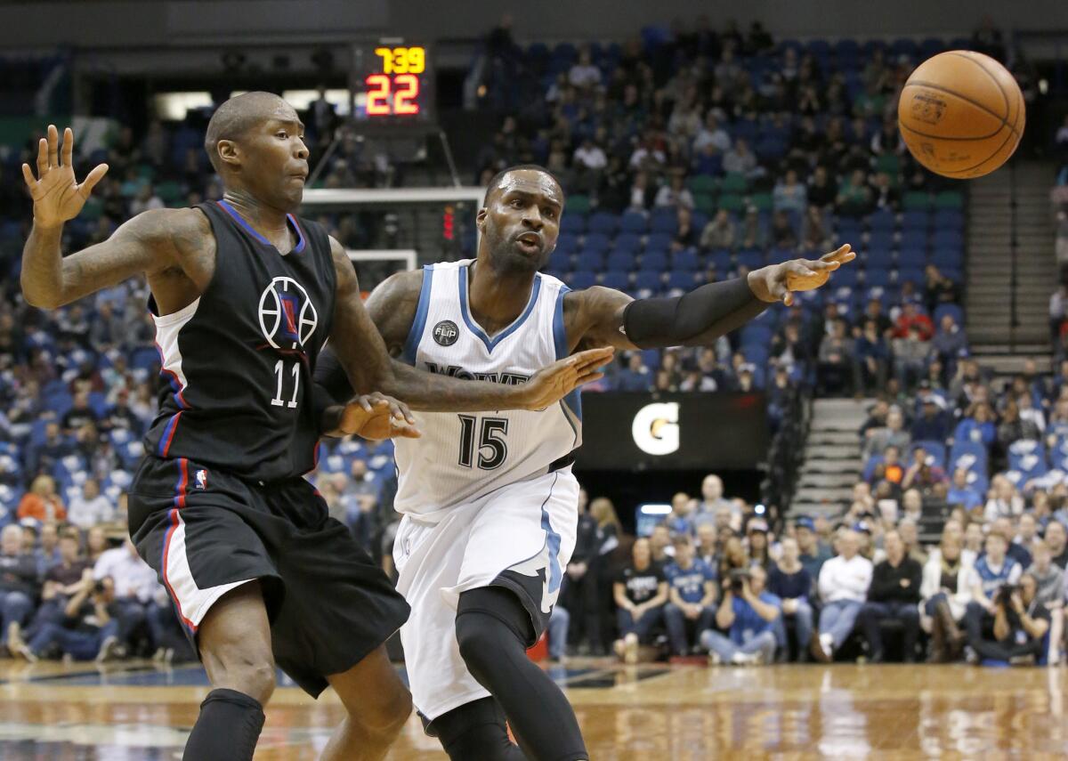 Timberwolves forward Shabazz Muhammad (15) passes to a teammate away from Clippers guard Jamal Crawford (11) during the first half.