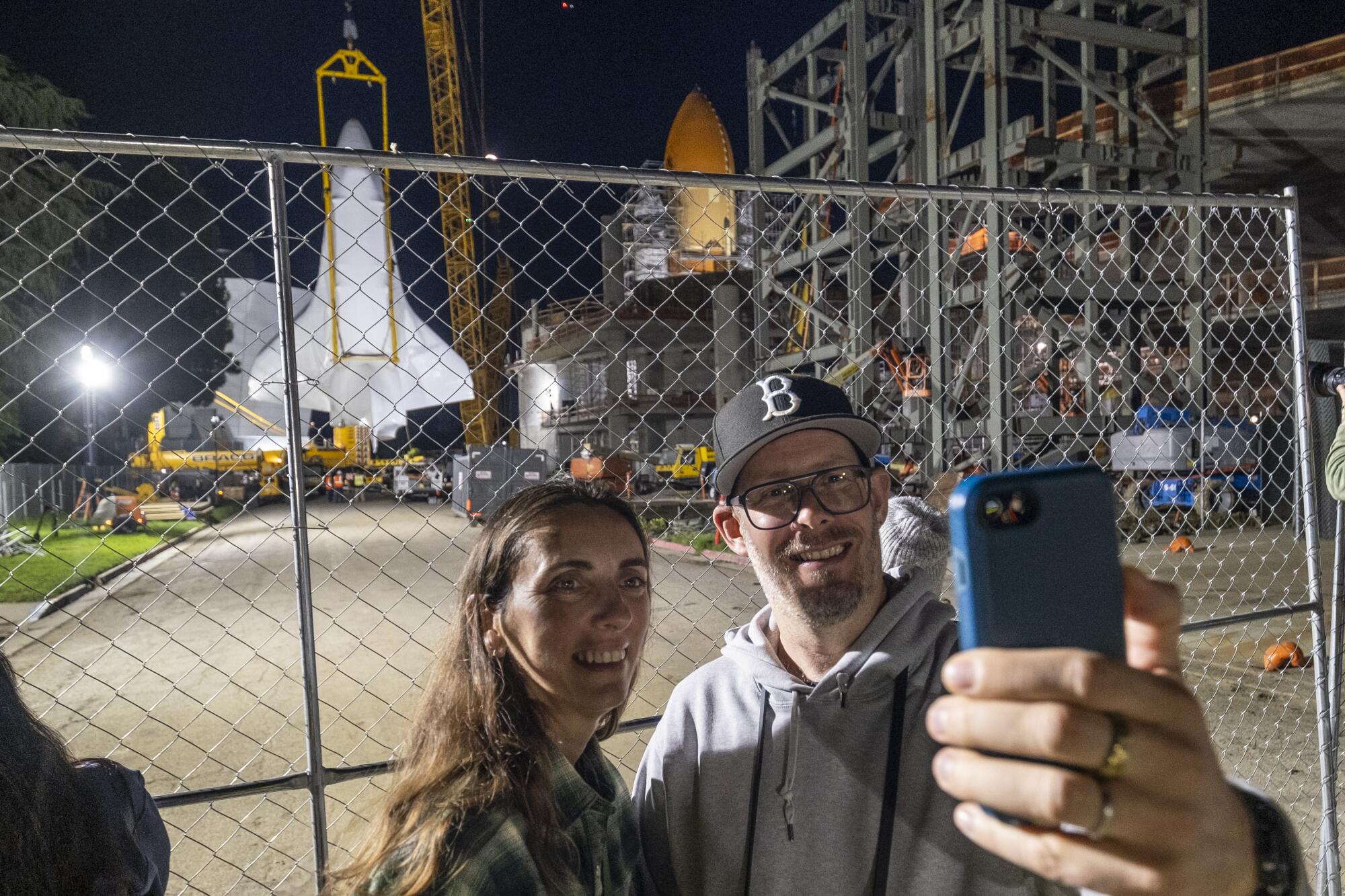 Piers Brinkley, right, and Clare David take photos in front of the space shuttle Endeavor.