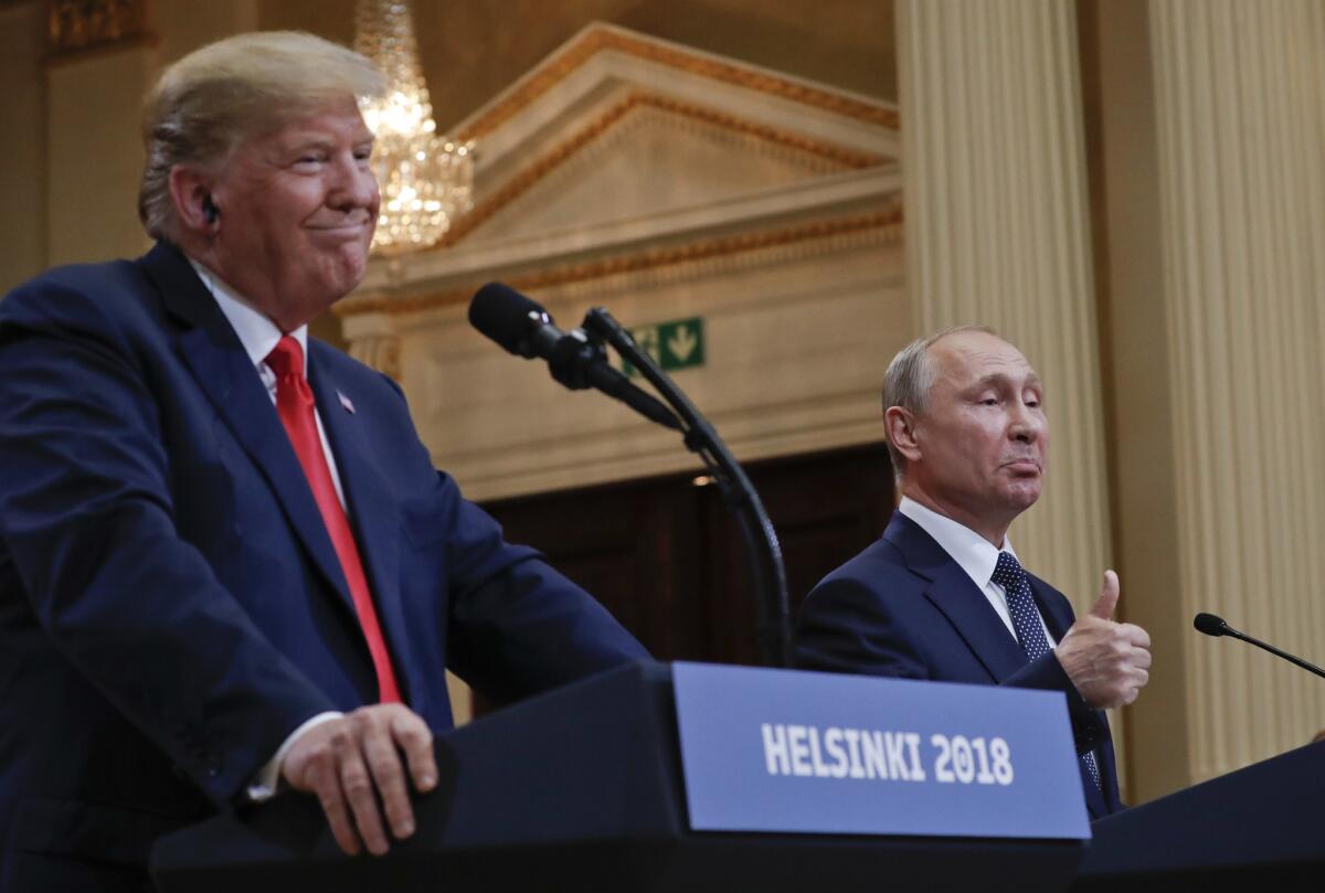 Russian President Vladimir Putin, right, with President Donald Trump, left, during their joint news conference at the Presidential Palace in Helsinki, Finland.