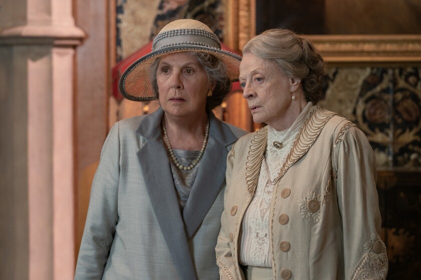 Two old women in formalwear look skeptical