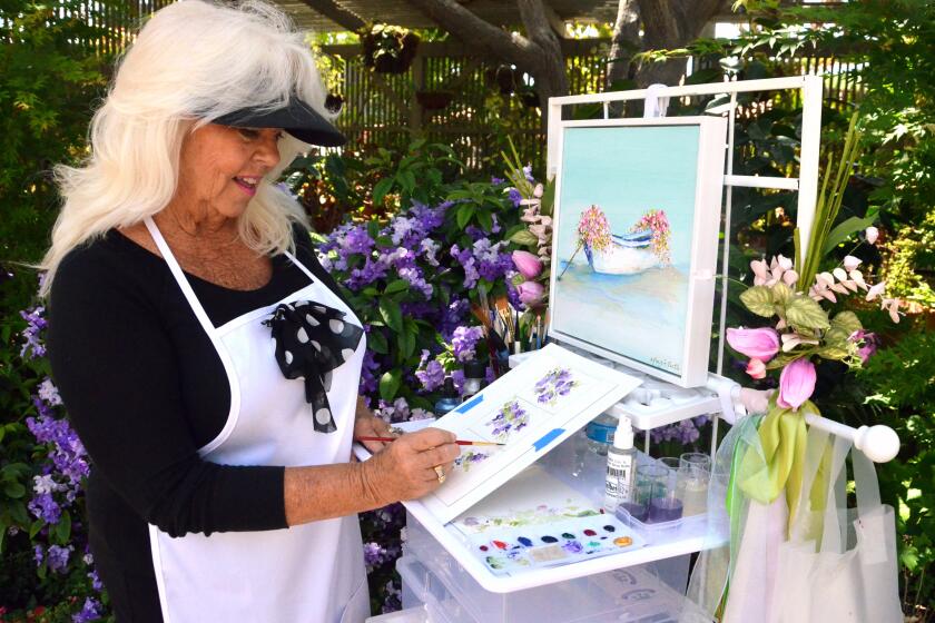 Margie Castle paints a work inspired by the nearby Brunfelsia blooms at Sherman Gardens.