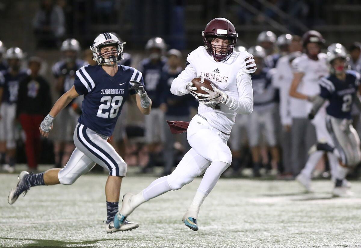 Sean Nolan pulls in a pass on the run and takes it to the end zone in Laguna Beach High's CIF Southern Section Division 12 quarterfinal playoff game against Northwood at Irvine High on Nov. 9, 2018.