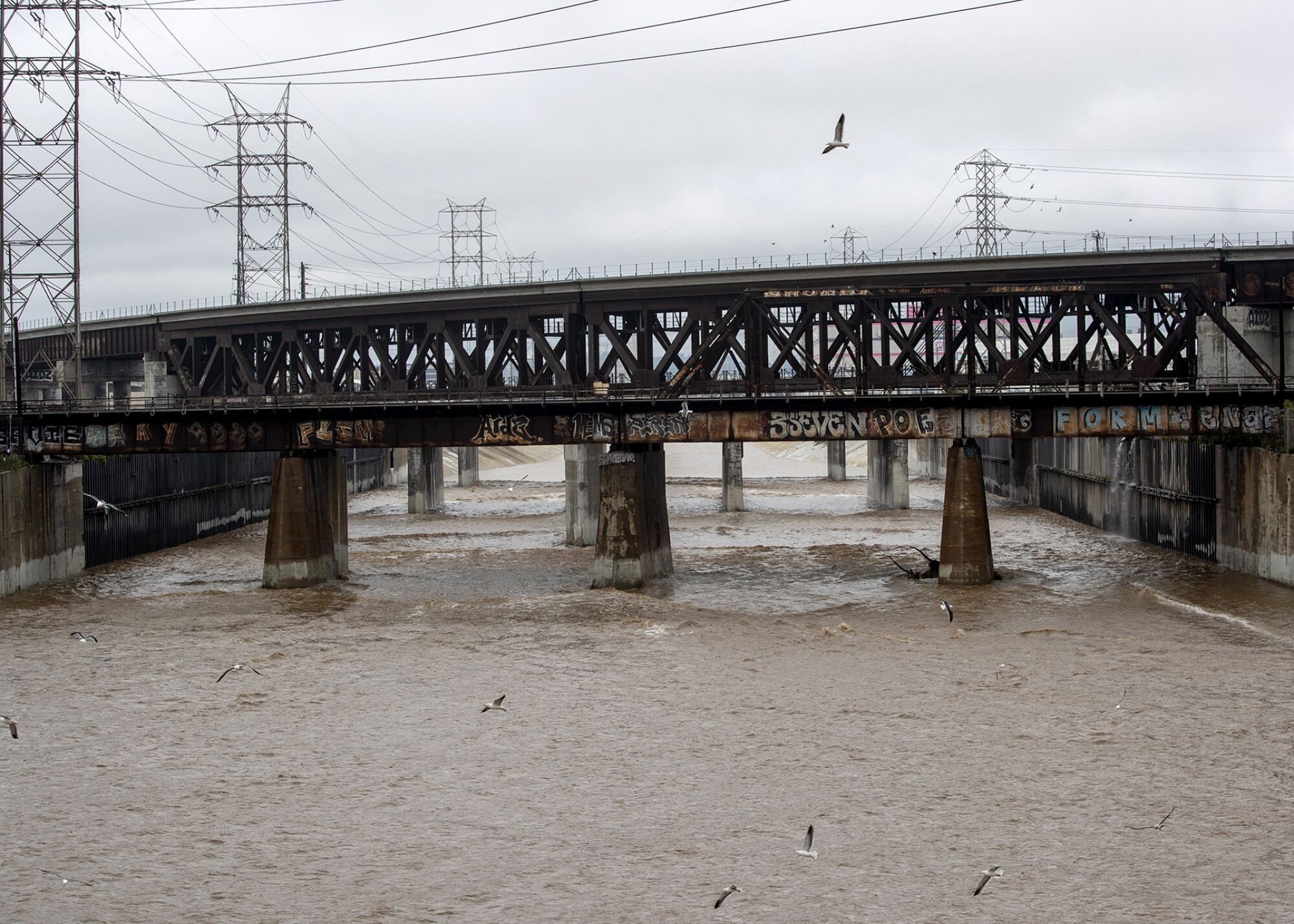 Muddy water fills the concrete-lined Los Angeles River in Vernon 