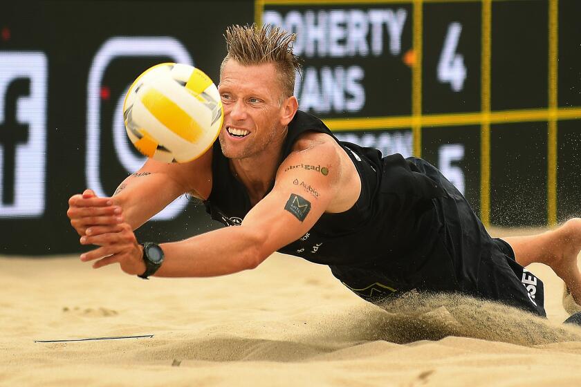Christina House??Los Angeles Times CASEY PATTERSON dives for the ball in the Hermosa Beach Open. He and his partner Chase Budinger defeated Miles Evans and Ryan Doherty 25-23, 19-21, 15-7. The victory marked Budinger’s first AVP title.