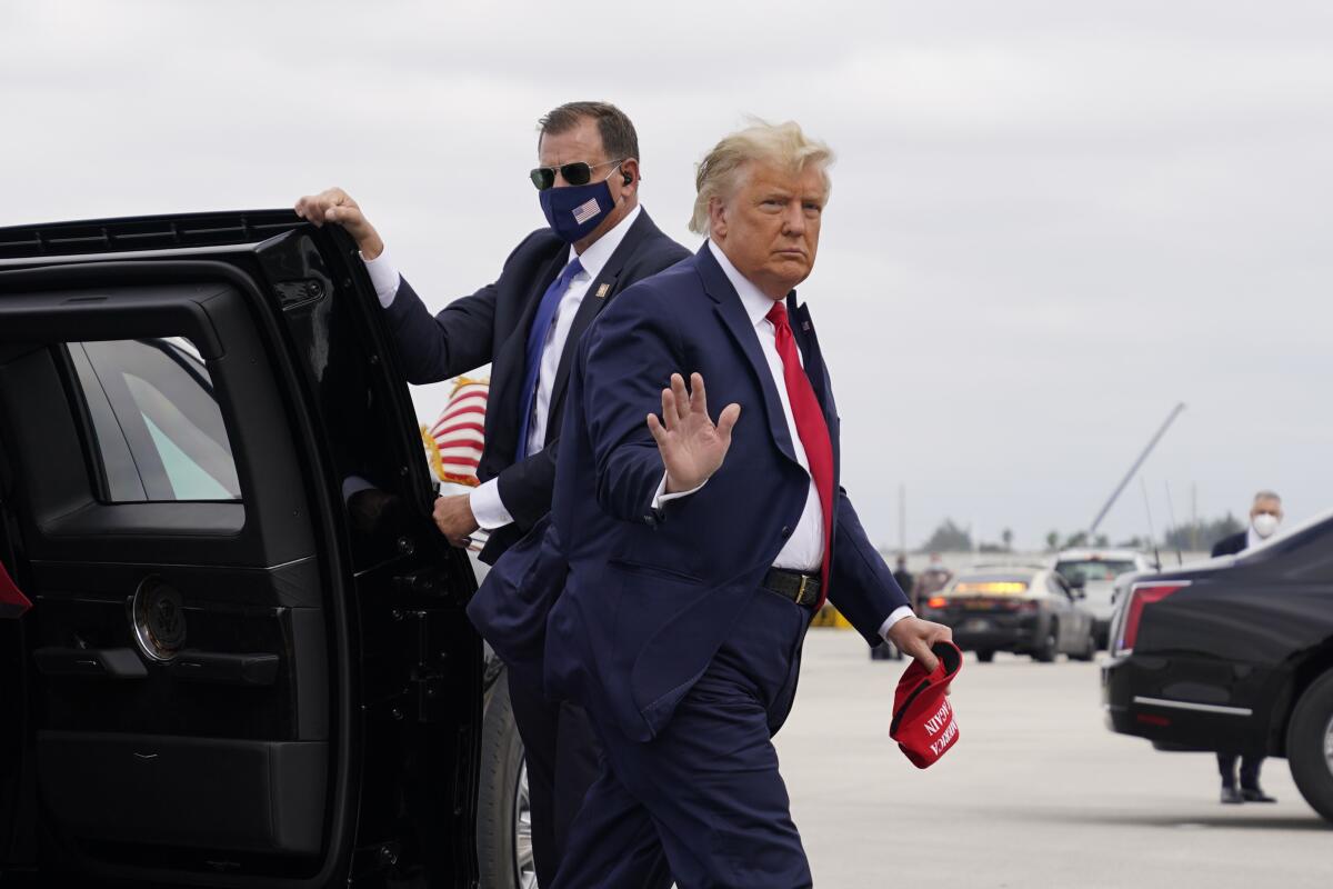 President Trump leaves his limo and waves to supporters.