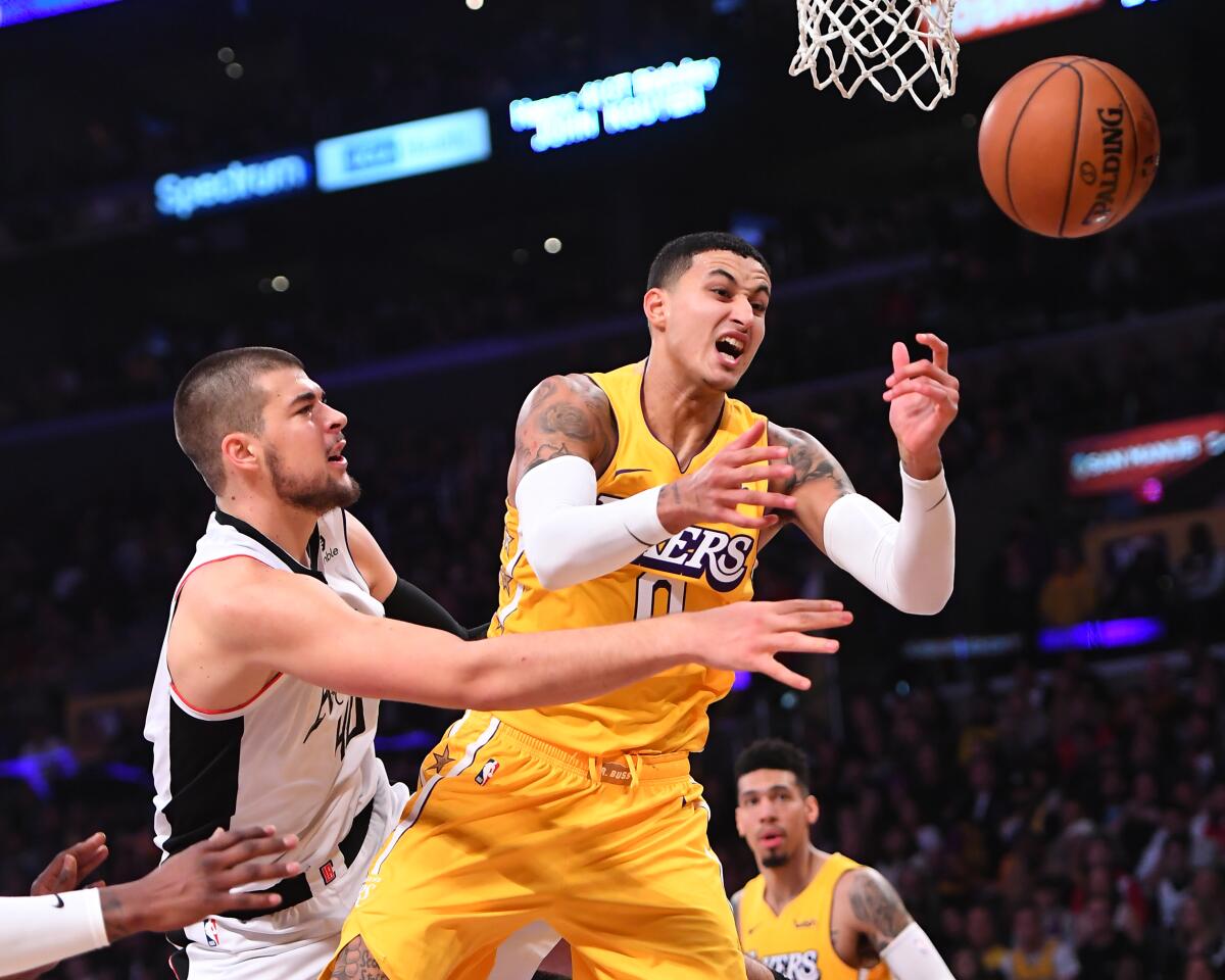 Clippers center Ivica Zubac battles Lakers forward Kyle Kuzma for the ball under the basket during the first half of a game Dec. 25, 2019.