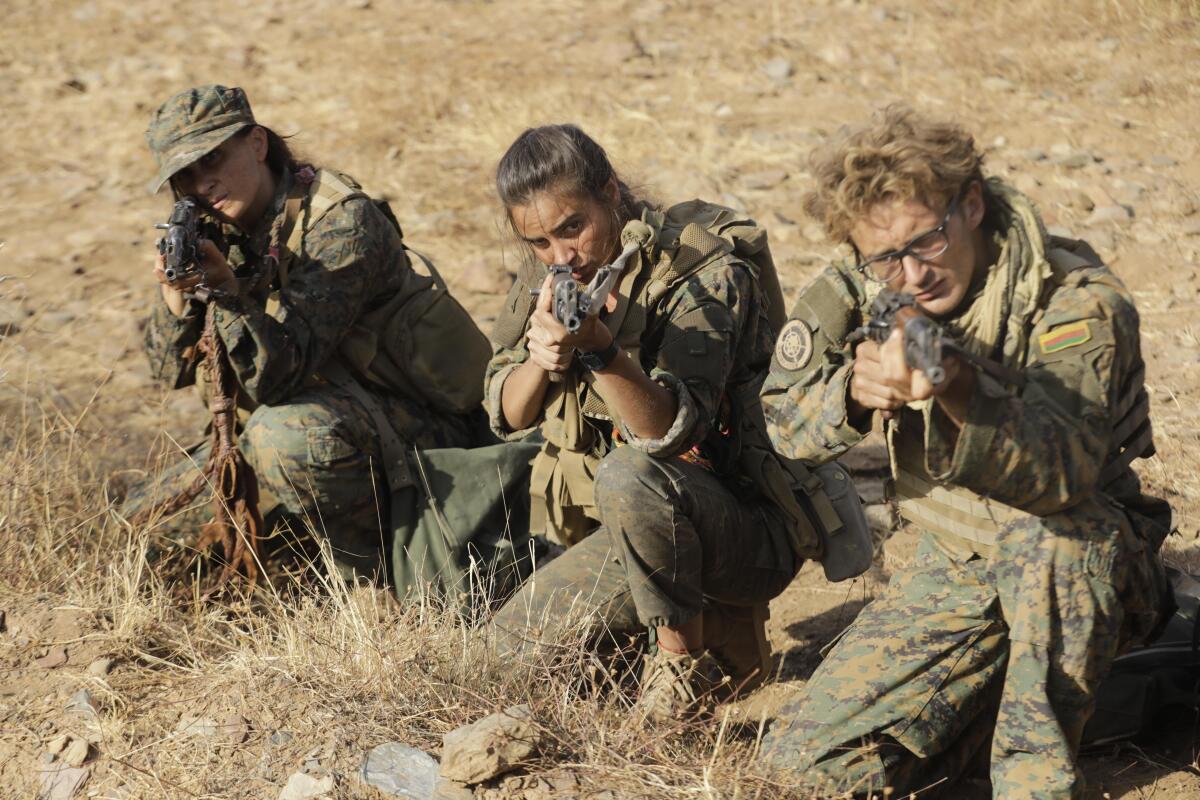 Luis Quintero (Luke Hornsby), right, is an American writer who joined the YPJ's cause.