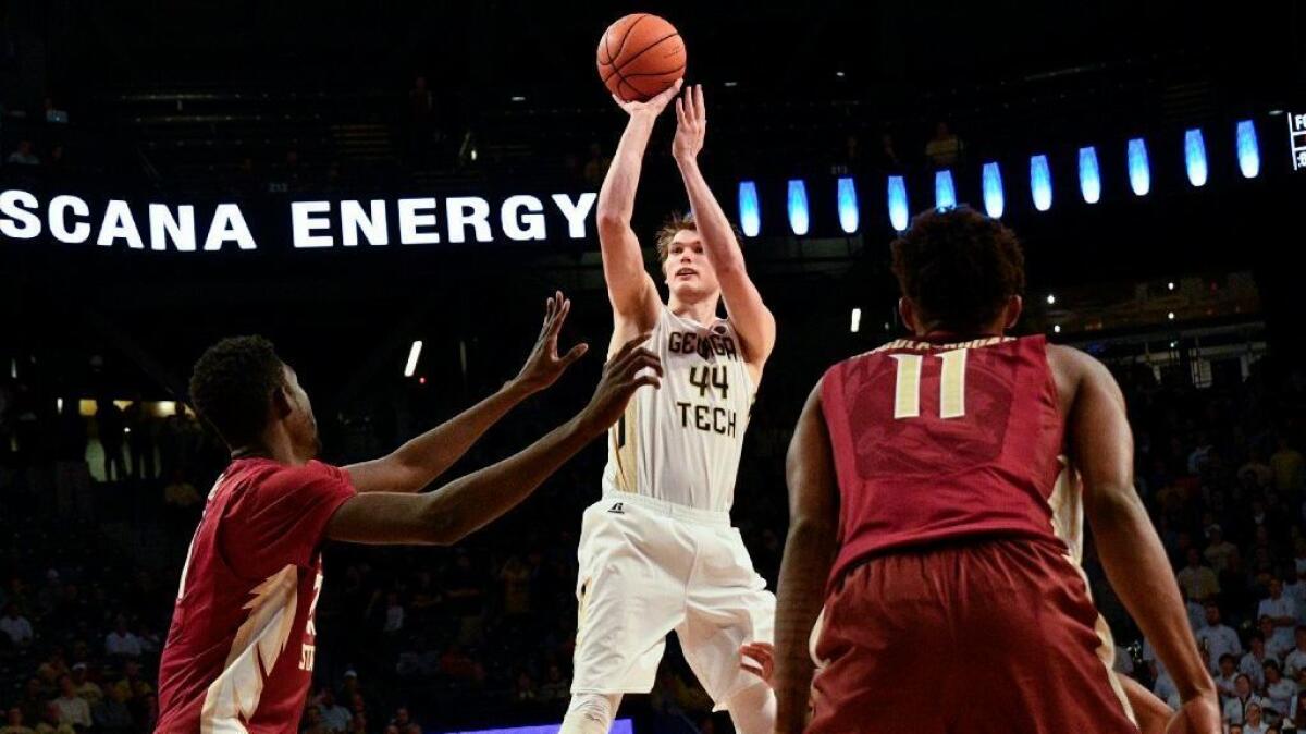 Georgia Tech center Ben Lammers shoots as Florida State center Christ Koumadje and guard Braian Angola-Rodas (11), defend during a game on Jan. 25.