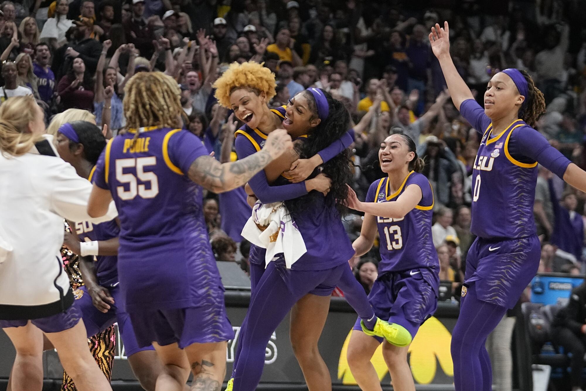 LSU players celebrate after defeating Iowa for the national title Sunday.