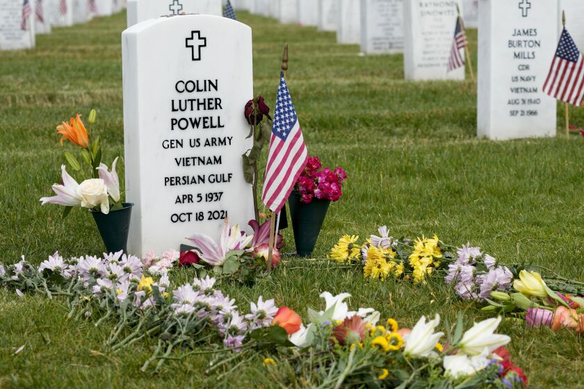 Flowers rest at the burial plot of former Secretary of State Colin Powell in Section 60 at Arlington National Cemetery on Memorial Day, Monday, May 29, 2023, in Arlington, Va. (AP Photo/Alex Brandon)
