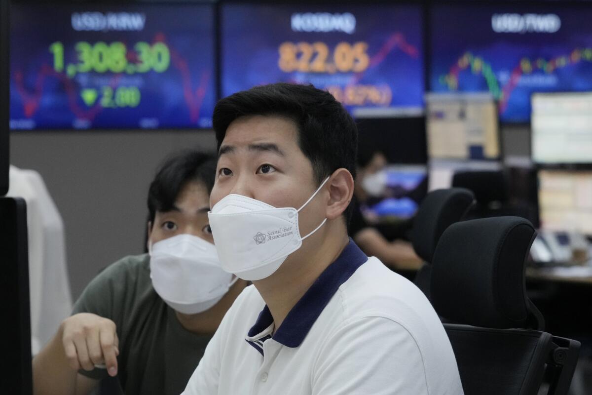 Currency traders watch monitors at the foreign exchange dealing room of the KEB Hana Bank headquarters in Seoul, South Korea, Thursday, Aug. 4, 2022. Asian shares mostly rose Thursday as investors welcomed encouraging economic data and quarterly earnings reports from big companies. (AP Photo/Ahn Young-joon)