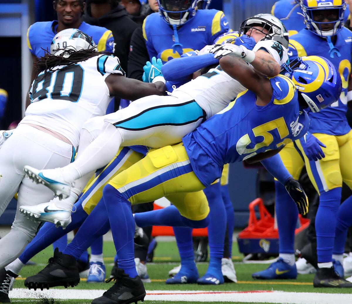 Panthers running back Christian McCaffrey is brought down hard by Rams linebacker Ernest Jones 