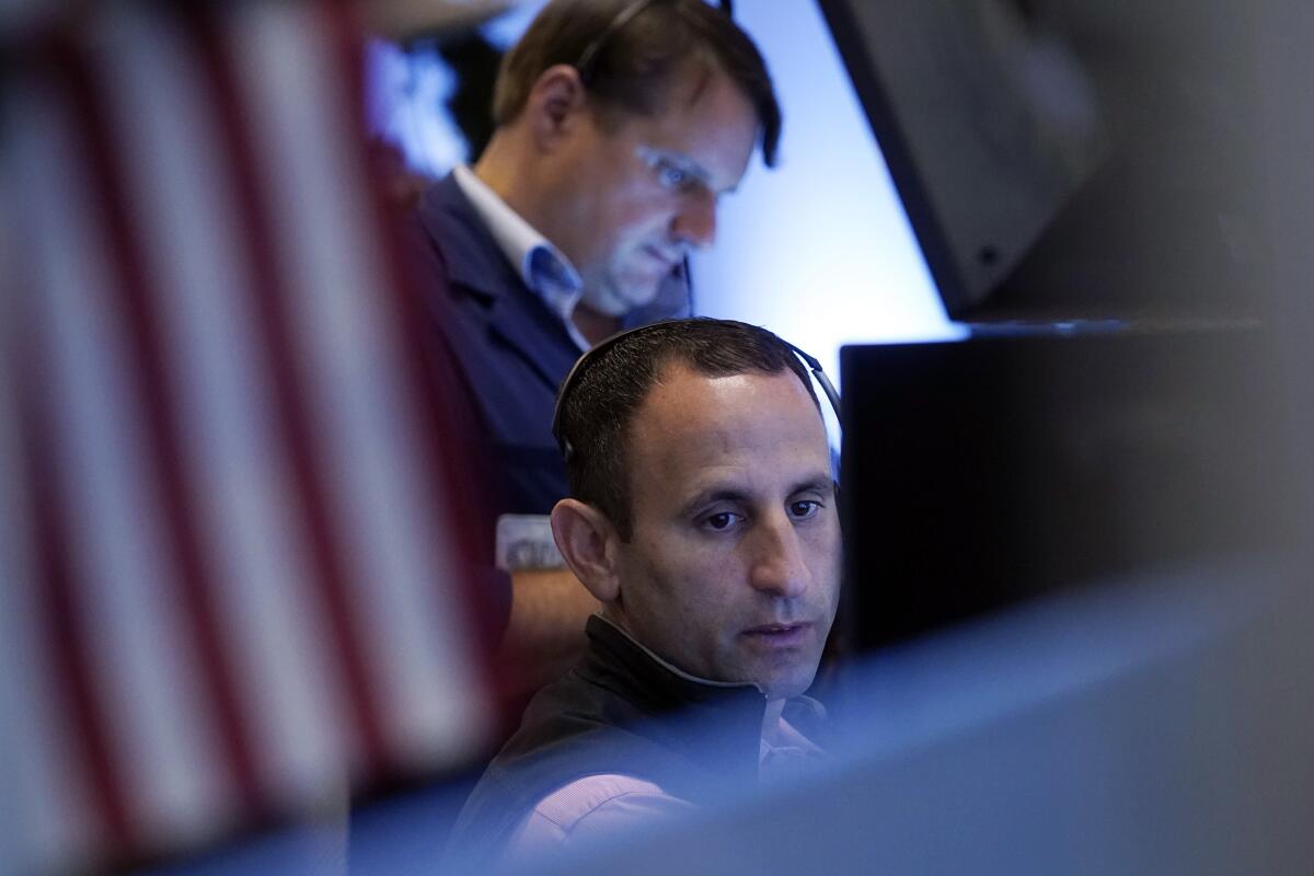 A pair of traders work on the floor of the New York Stock Exchange