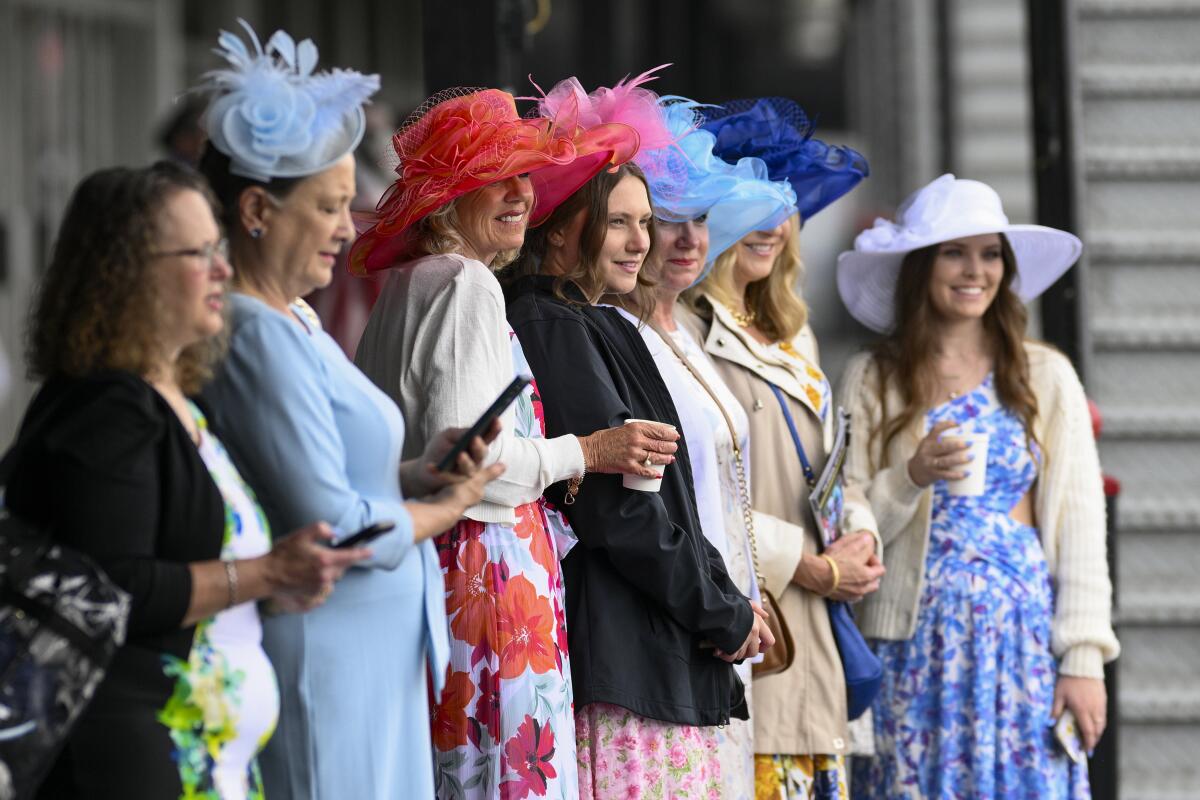 Women wear decorative hats ahead of the Preakness Stakes horse race at Pimlico Race Course Saturday in Baltimore. 
