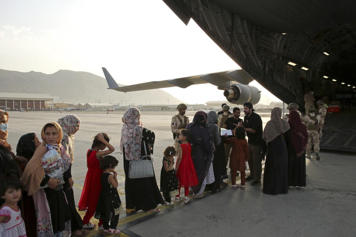 Afghans boarding Qatari transport plane for evacuation