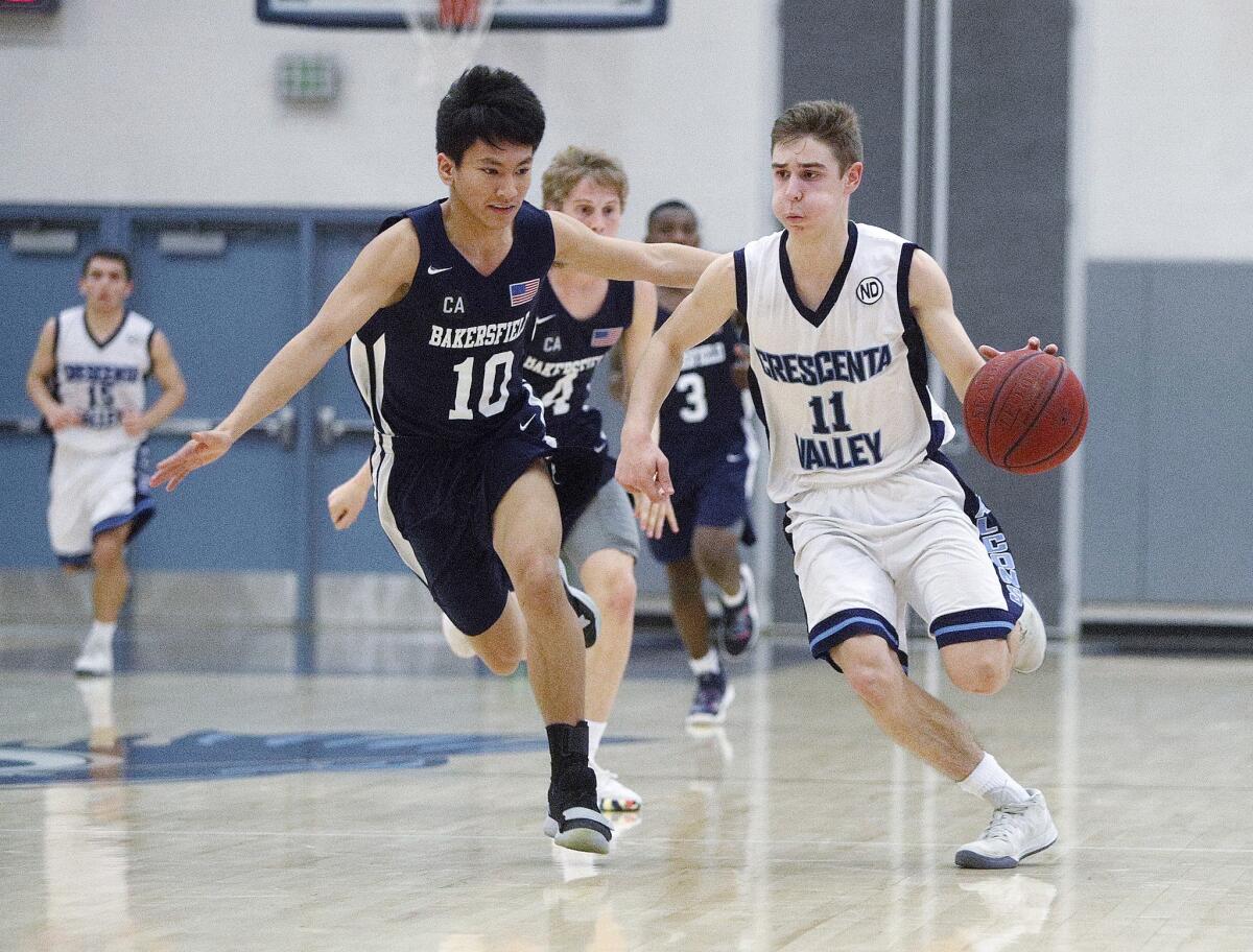 Crescenta Valley's Tyler Carlson, seen here in a file photo, led all scorers with 32 points in the Falcons' 73-70 overtime league victory against Pasadena on Tuesday.