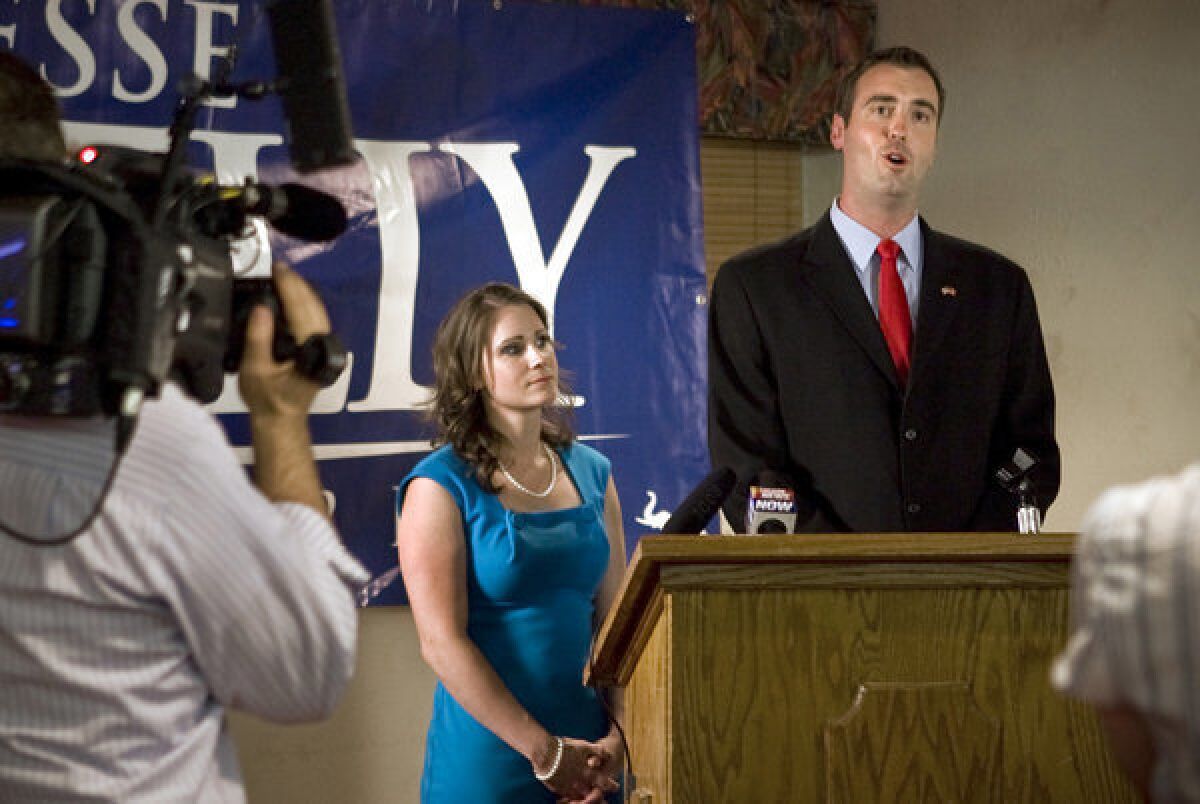 Jesse Kelly, with wife Aubrey, delivers his concession speech on election night in Tucson on Tuesday.