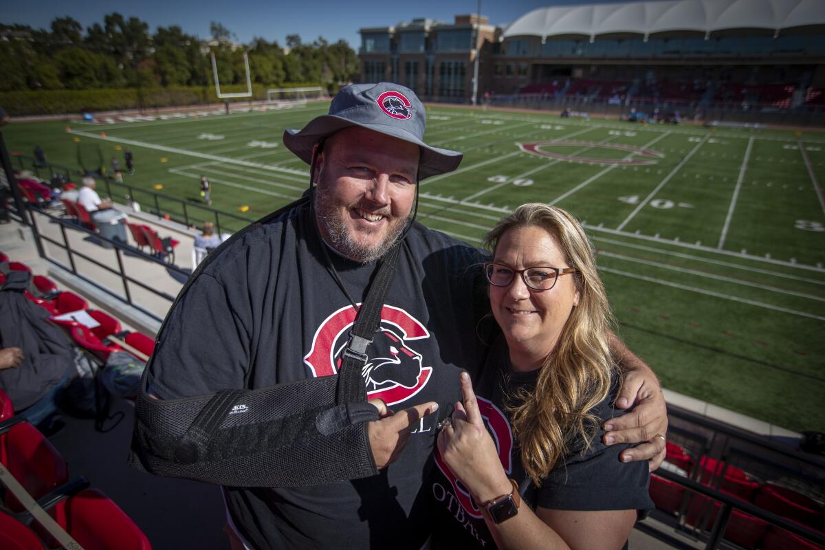Dan and Julia Wilbanks arrive to watch their son, Chapman offensive lineman Jacob Wilbanks, play against Linfield on Saturday.