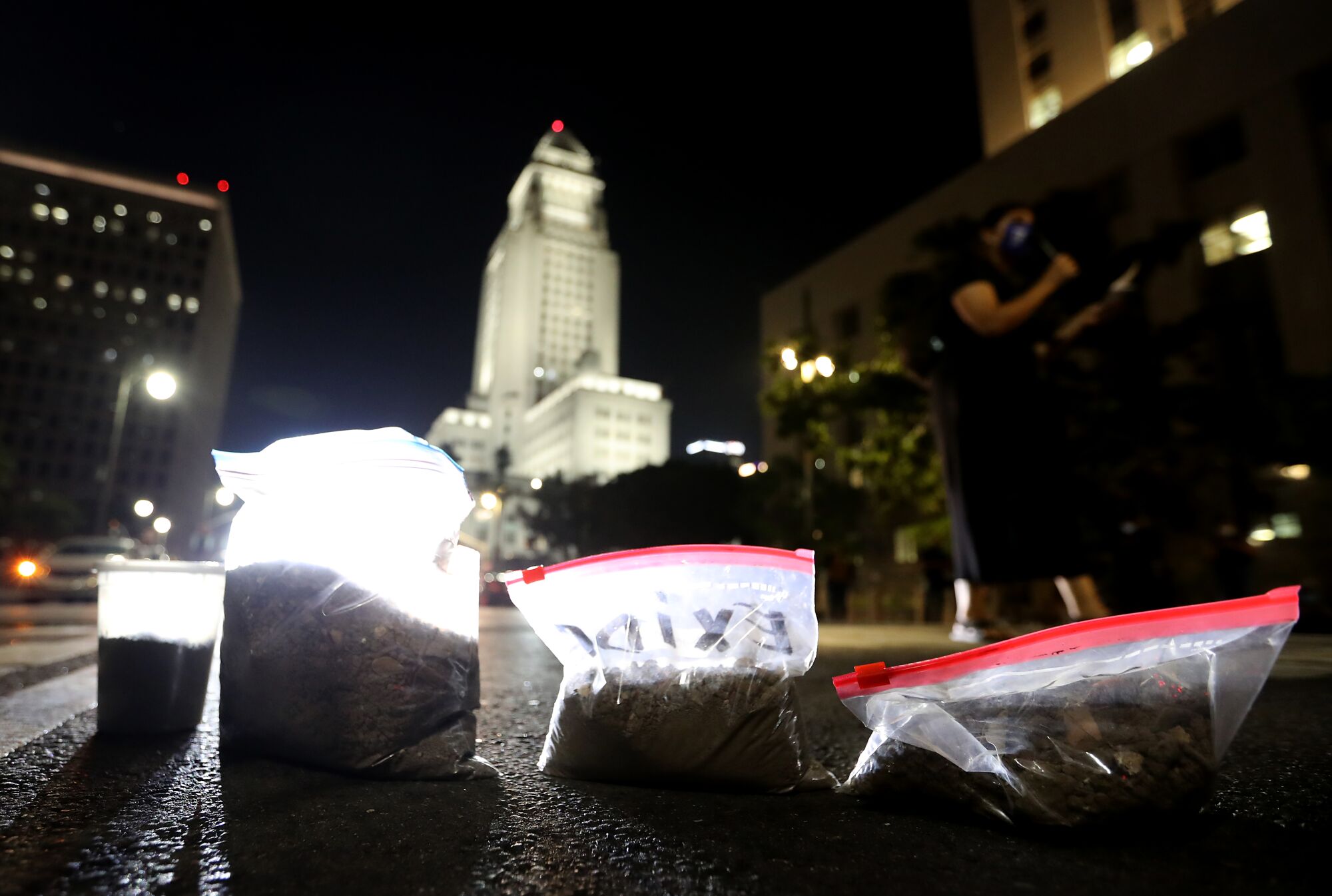 Bags of dirt lay on a street outside Los Angeles City Hall.