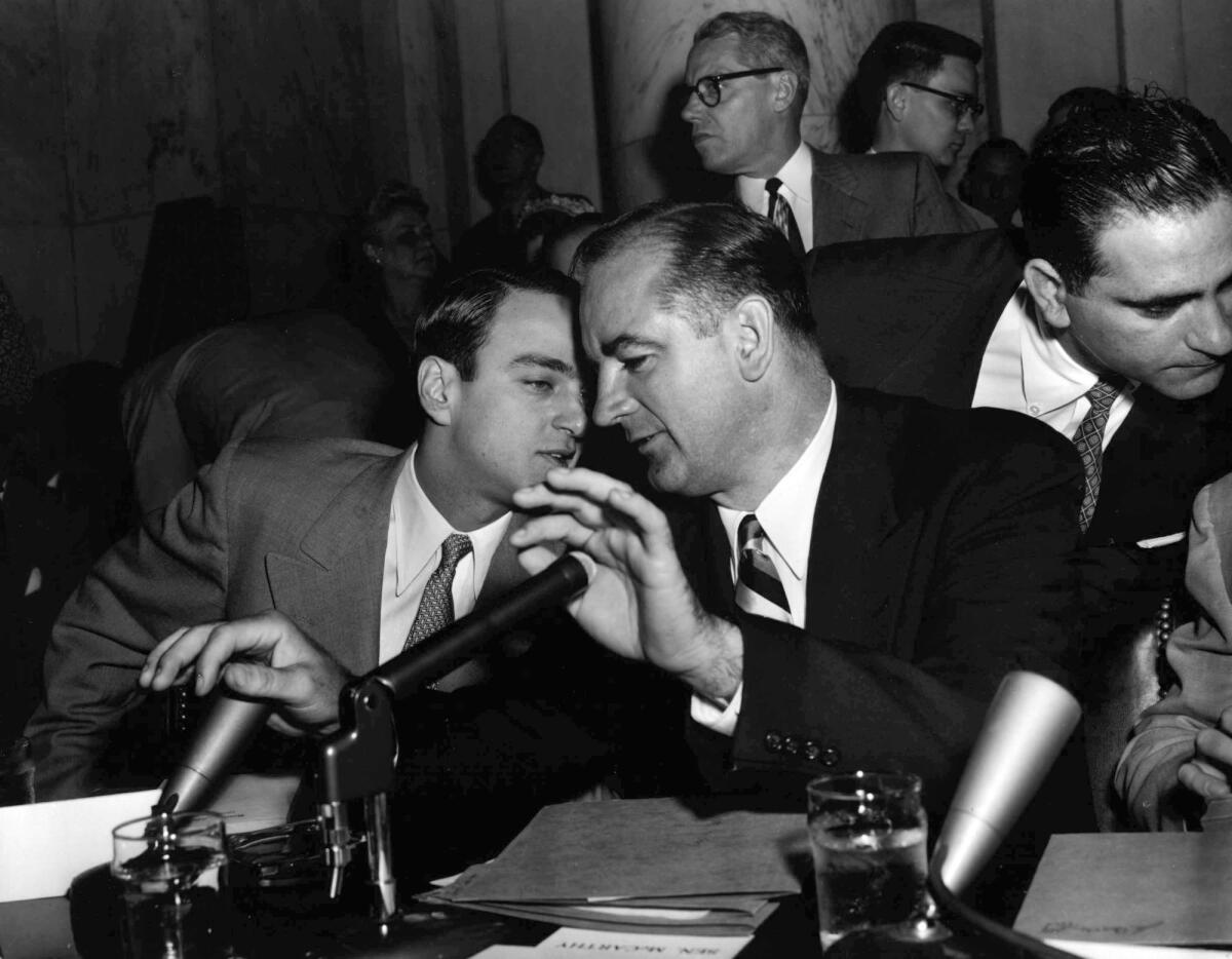 Sen. Joseph McCarthy speaks to his chief counsel, Roy Cohn, during the Senate's Army-McCarthy hearings in April 1954.