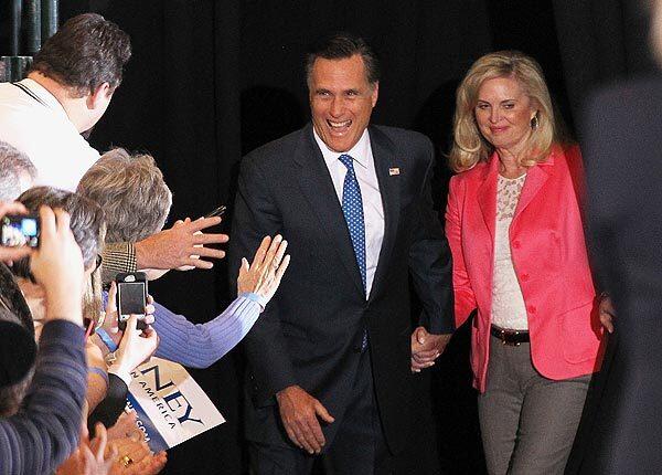 Mitt Romney and his wife, Ann, arrive for a Super Tuesday gathering in Boston.