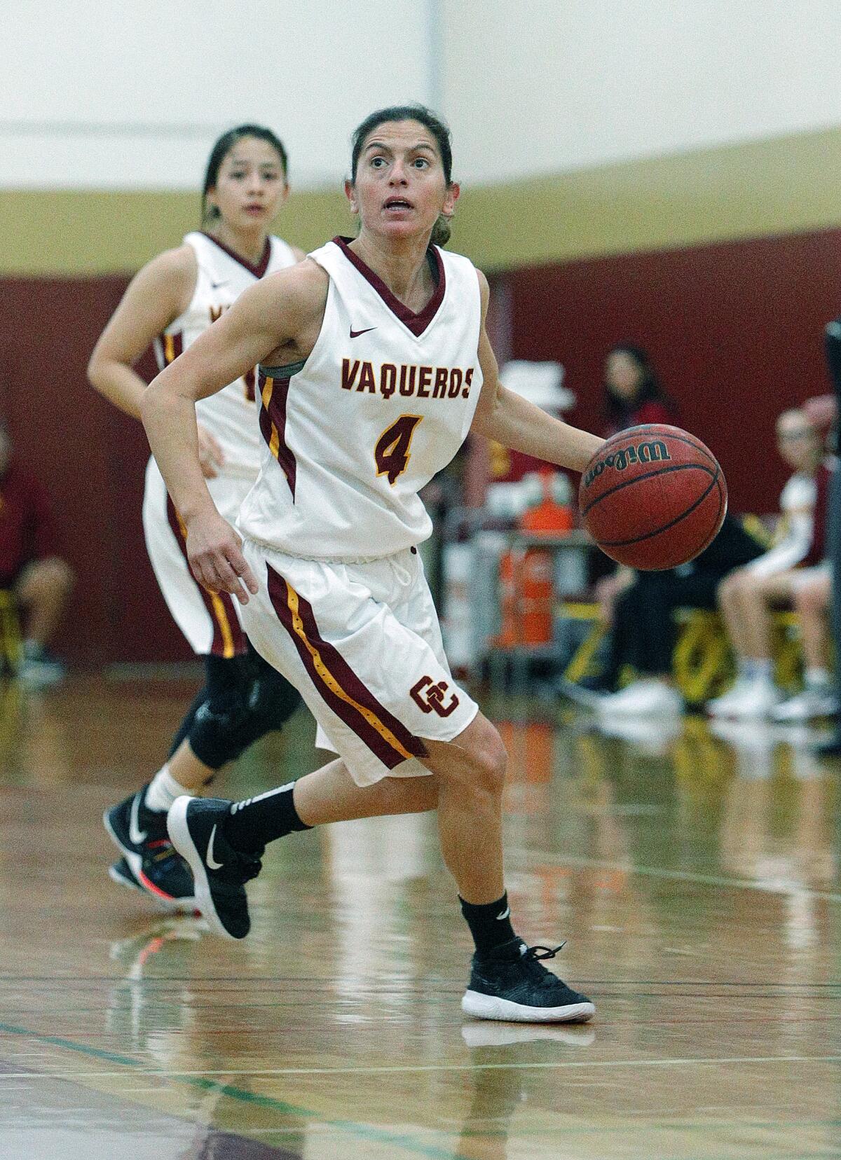 Glendale Community College's Vicky Oganyan checks for a shot while dribbling outside the three-point circle in a women's basketball game against Allan Hancock in the annual Vaquero basketball tournament at Glendale Community College on Wednesday, December 18, 2019. Oganyan is the long-time head coach of the Burroughs High School girls' basketball team and is playing for GCC while taking classes at GCC. Glendale won the game to improve to 10-1 on the season by defeating Allan Hancock 58-50.