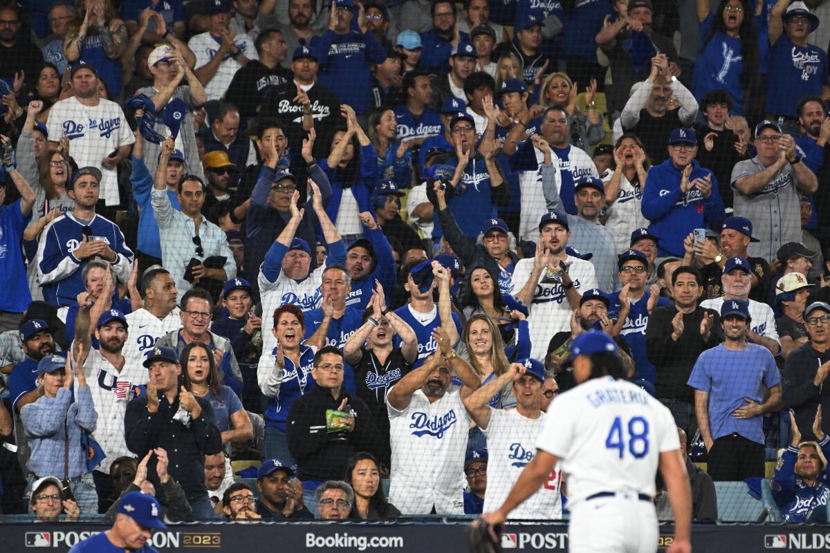 Dodgers fans give reliever Brusdar Graterol a standing ovation as he walks to the dugout at Dodger Stadium.