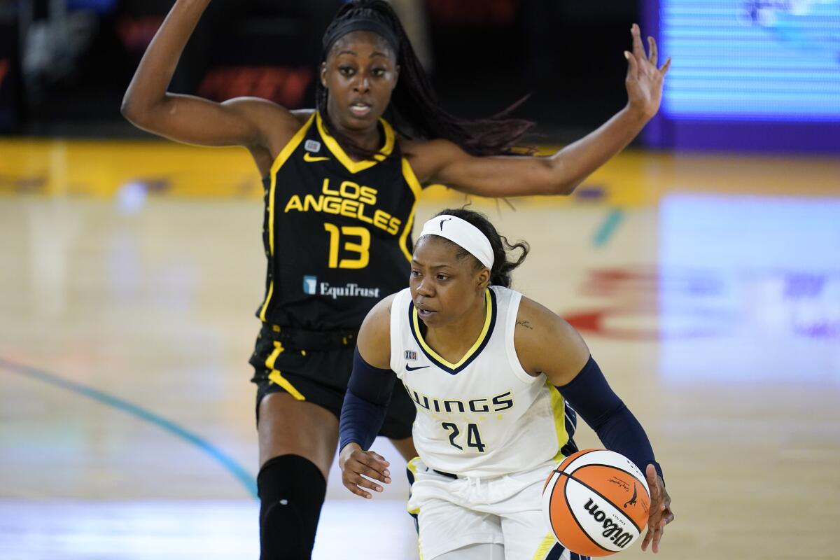 Los Angeles Sparks forward Chiney Ogwumike (13) defends against Dallas Wings guard Arike Ogunbowale (24) during the first quarter of a WBNA basketball game Friday, May 14, 2021, in Los Angeles. (AP Photo/Ashley Landis)